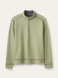 Light green stretch-cotton quarter-zip top with reversible light grey inside, flat lay, front view with contrast seam stitching.