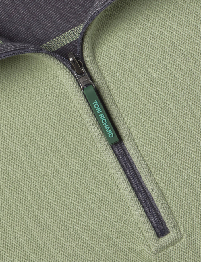 Green reversible quarter-zip pullover, close-up of front with TOM RICHARD zipper pull (Images 1 & 2).