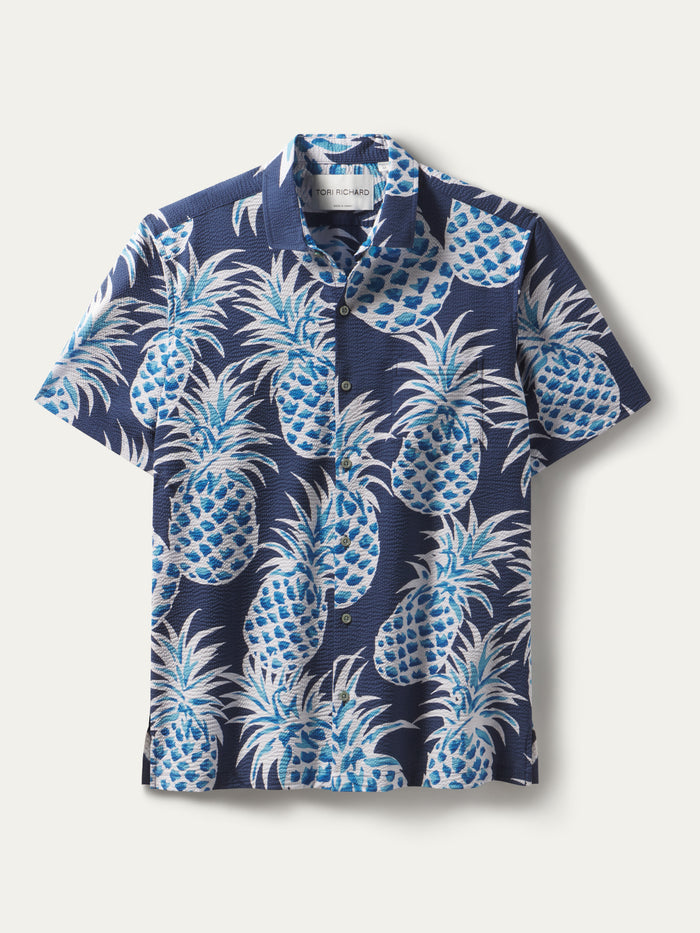 Navy blue pineapple-print short-sleeve button-up shirt, front view.