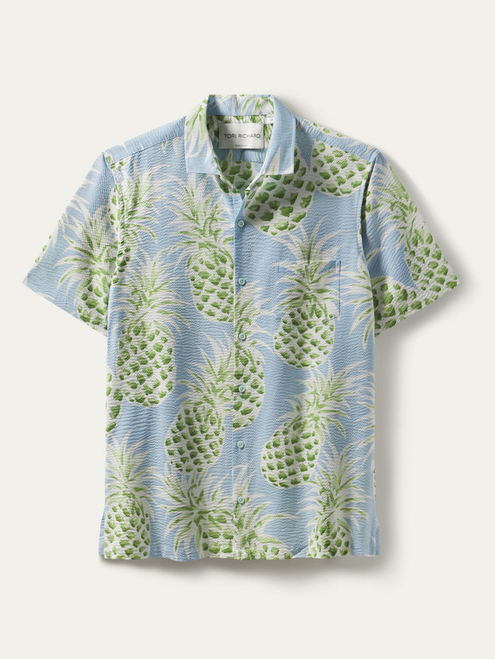 Light blue short-sleeve shirt, green/white pineapple print, cotton lawn, button front view.