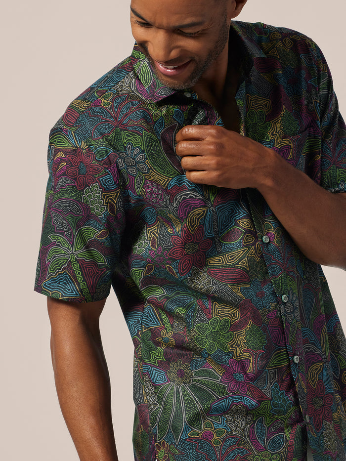 Neutral floral and leaf-print cotton short-sleeve shirt, front view on man.