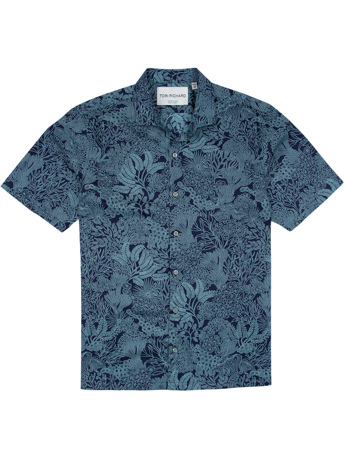 Blue floral, coral, and seaweed-print short-sleeve cotton shirt, front view on white background.