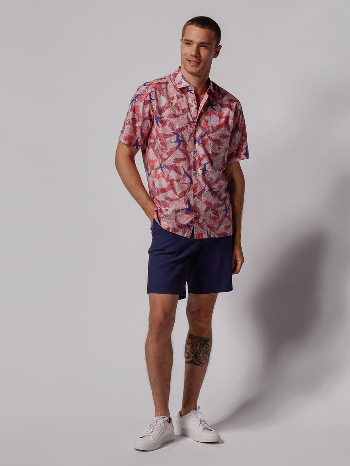 Red Cruising Terns graphic tee, navy shorts, white sneakers, front view.