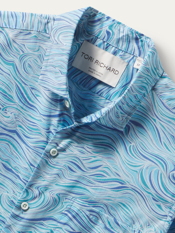 Blue and white swirl button-up shirt in cotton lawn, front view with collar label shown.