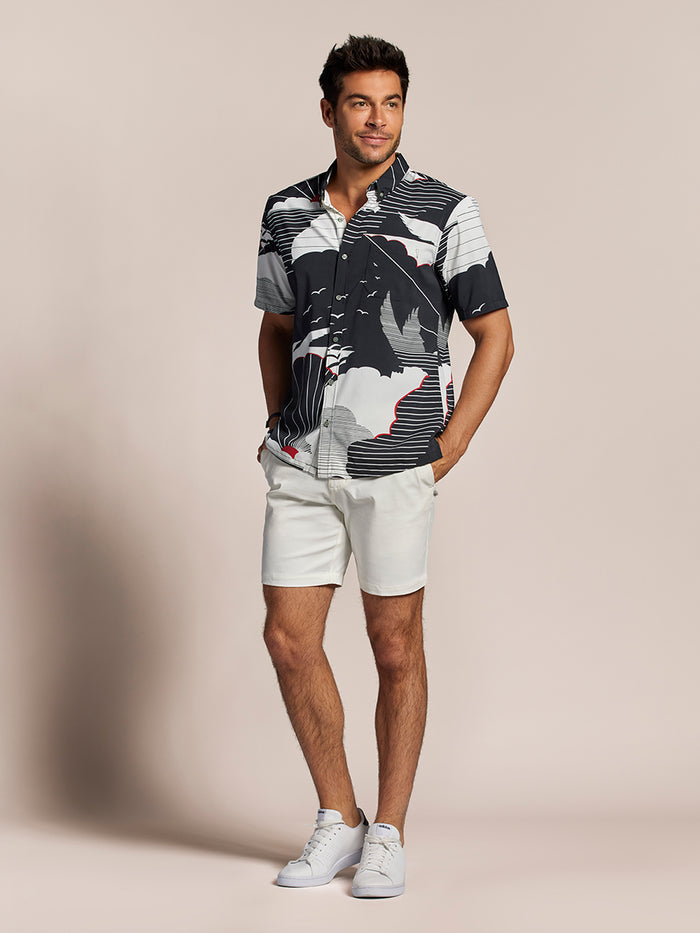 Black and white colorblock short-sleeve shirt with white shorts and sneakers, front view