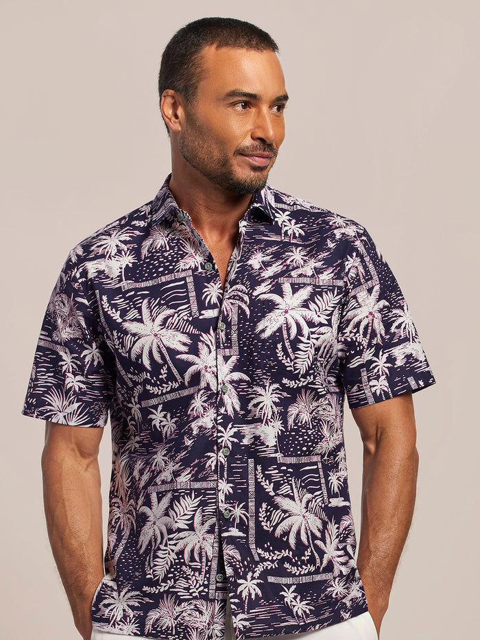 Black and white pinkish palm-print short-sleeve cotton shirt, Hawaiian shirt, side view on model, plain background.
