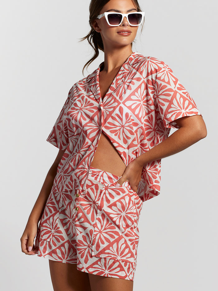 Pink and white cotton voile shirt and shorts set, solid color, casual front view with sunglasses.