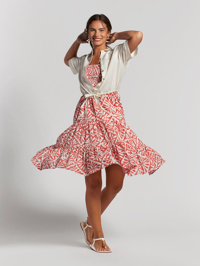 Red Deja Vu Joycie convertible skirt with light shirt and sandals, front view.