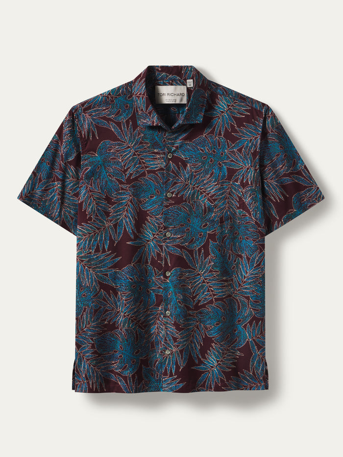 Blue and teal tropical leaf-print short-sleeve cotton shirt with Japanese-inspired pattern, front view.