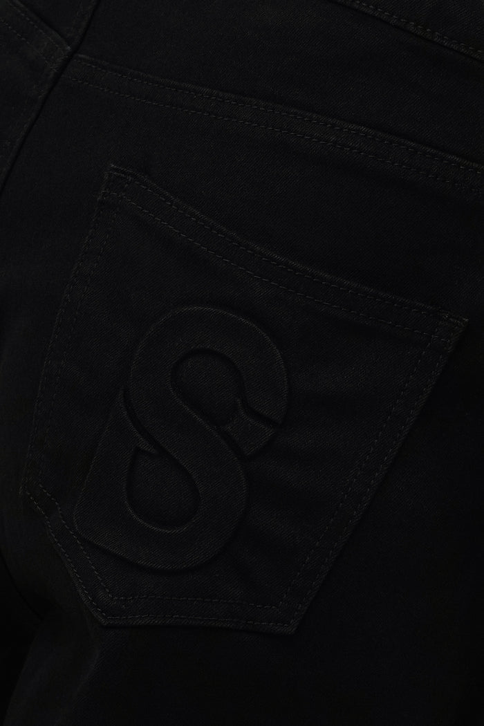 emma baggy denim pants in black by buttonscarves signature b detail