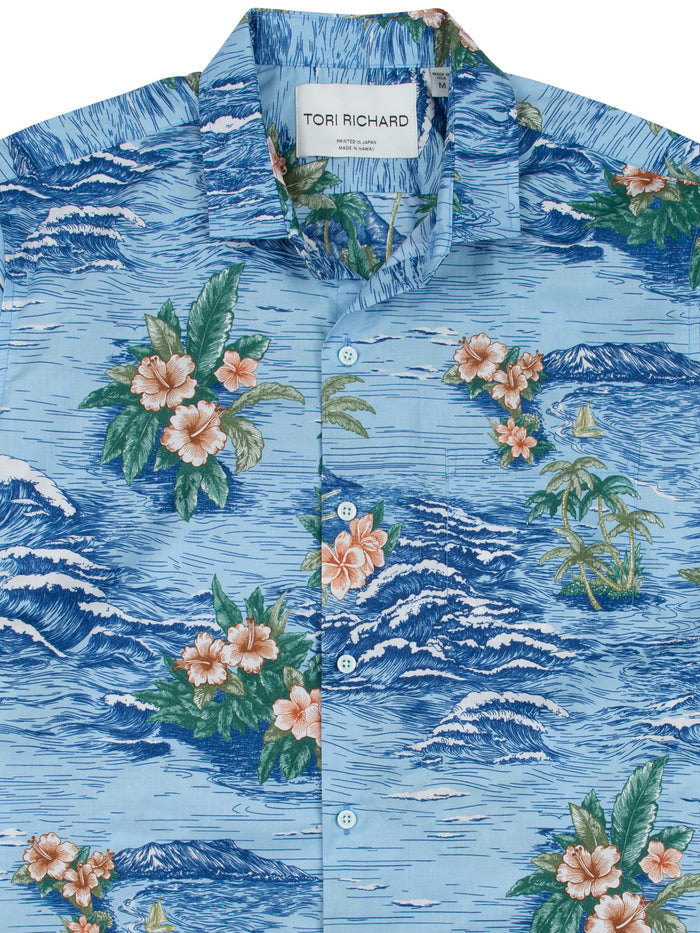 Blue floral and wave-print Hawaiian cotton lawn shirt with boats, full buttoned collar, front view.