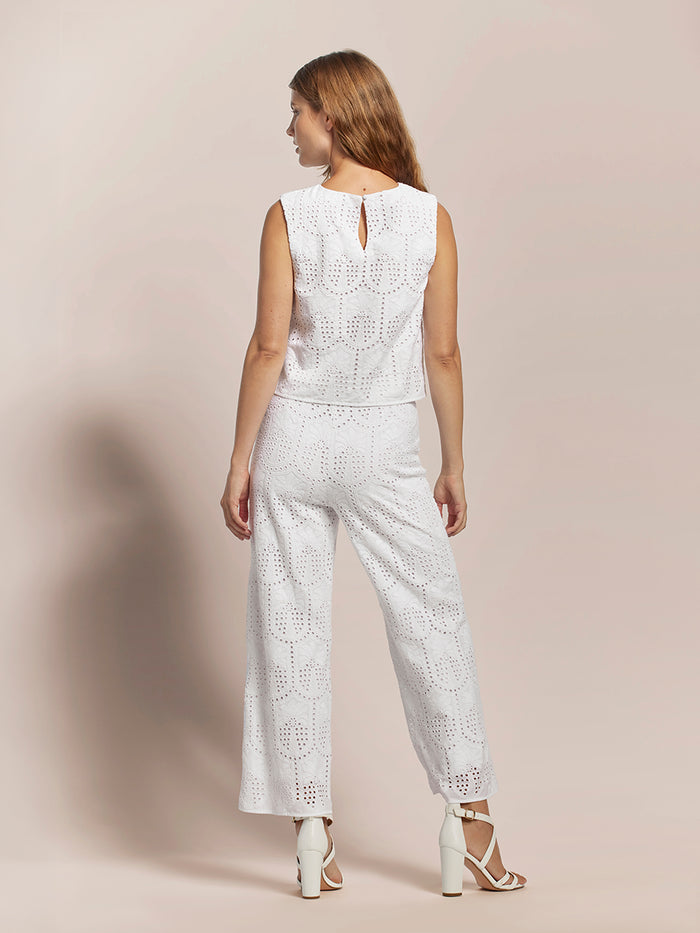 White sleeveless top and white palm-eyelet pants, back view.