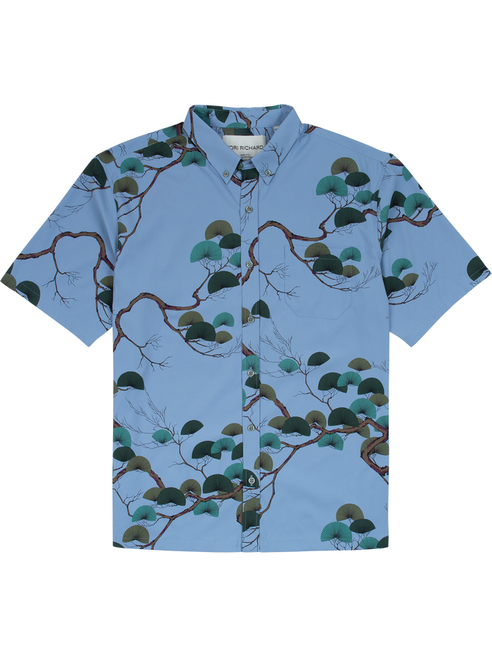 Light blue, short-sleeve shirt with Japanese pine and green foliage print, front view.