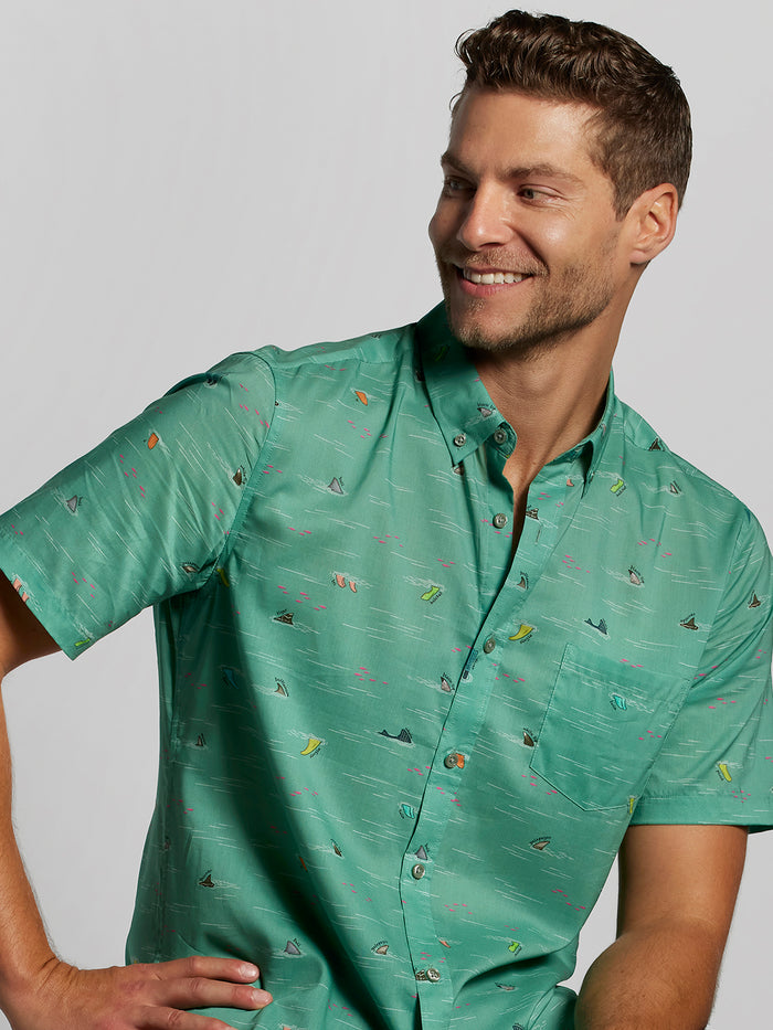 Green sailboat-print cotton-tencel short-sleeve shirt, left side view of wearer in both images.