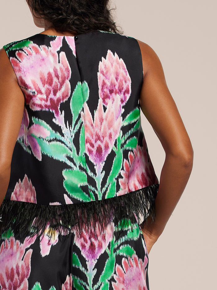 Black, Pink and Green, floral-print  sleeveless crop top with ostrich feather trim, back view.