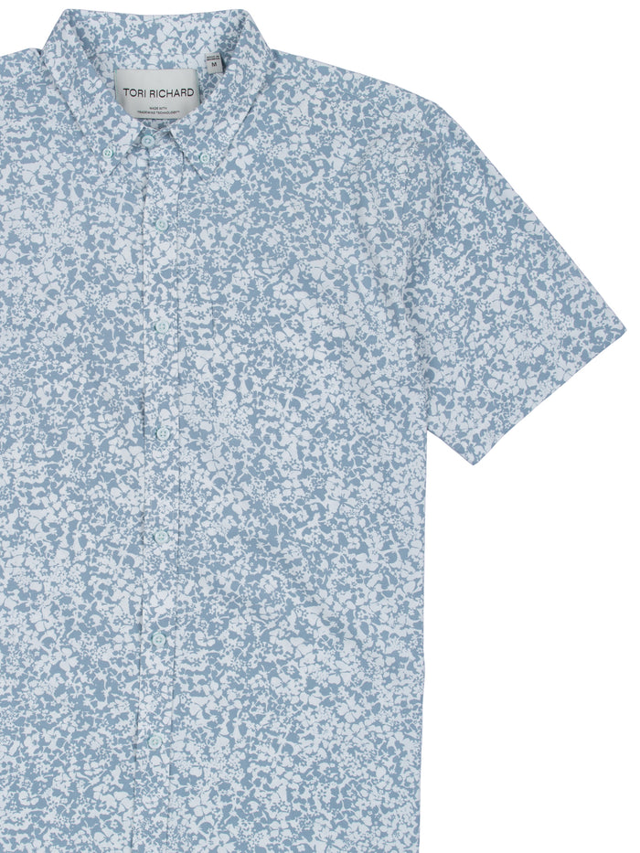 Light blue and white floral short-sleeve shirt, partial front view shown in both images.