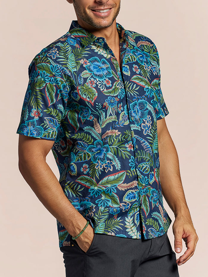 Navy cotton short-sleeve shirt with blue, green, and red tropical leaves prints front view.