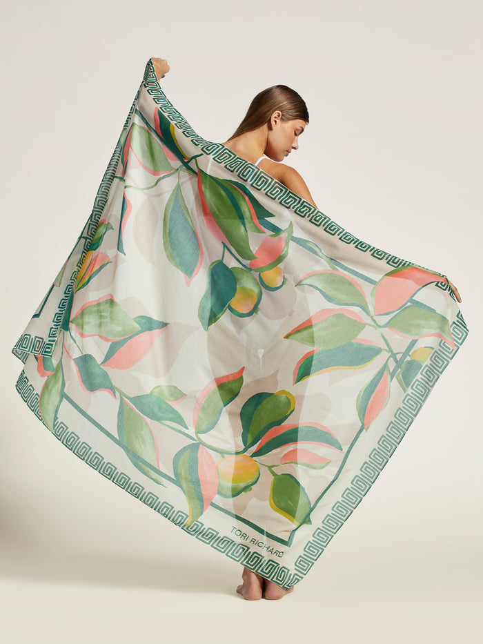 Sheer multicolor cas fruit-print pareo with vibrant pattern, worn by woman, full front view (two images).