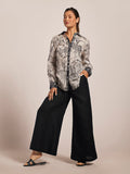 Ivory oversized Laila top, black wide-leg pants, and sandals—full and front outfit views.