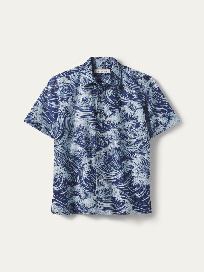 Blue and white ocean wave-print short-sleeve button-up shirt, front view.