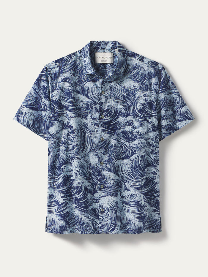 Blue and white wave-print short-sleeve button-up shirt, front view, on plain background.