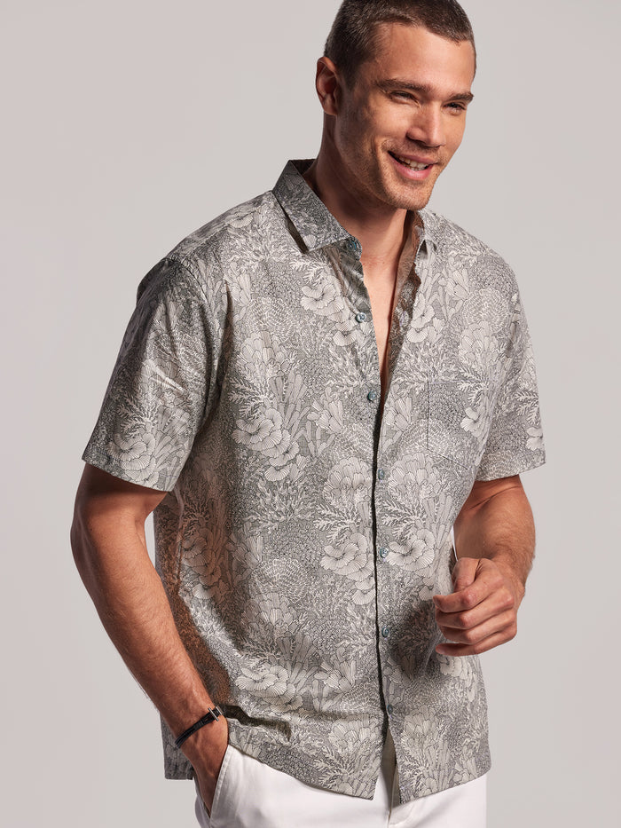 Good Reef! graphic short-sleeve shirt, man shown from side with hand in pocket.