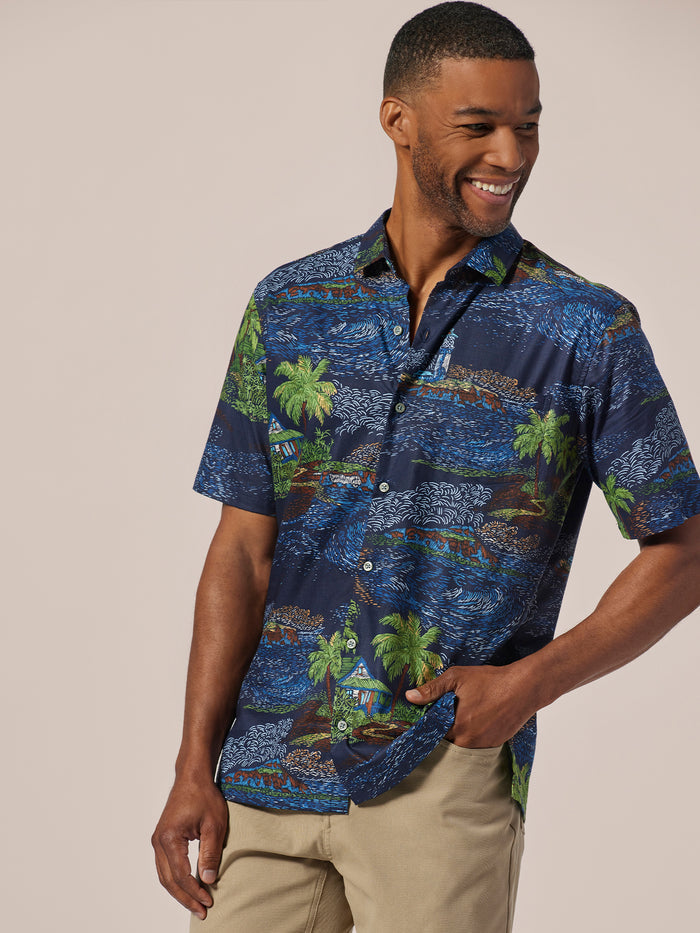 Blue cotton lawn short-sleeve shirt, plain, front view with beige pants .