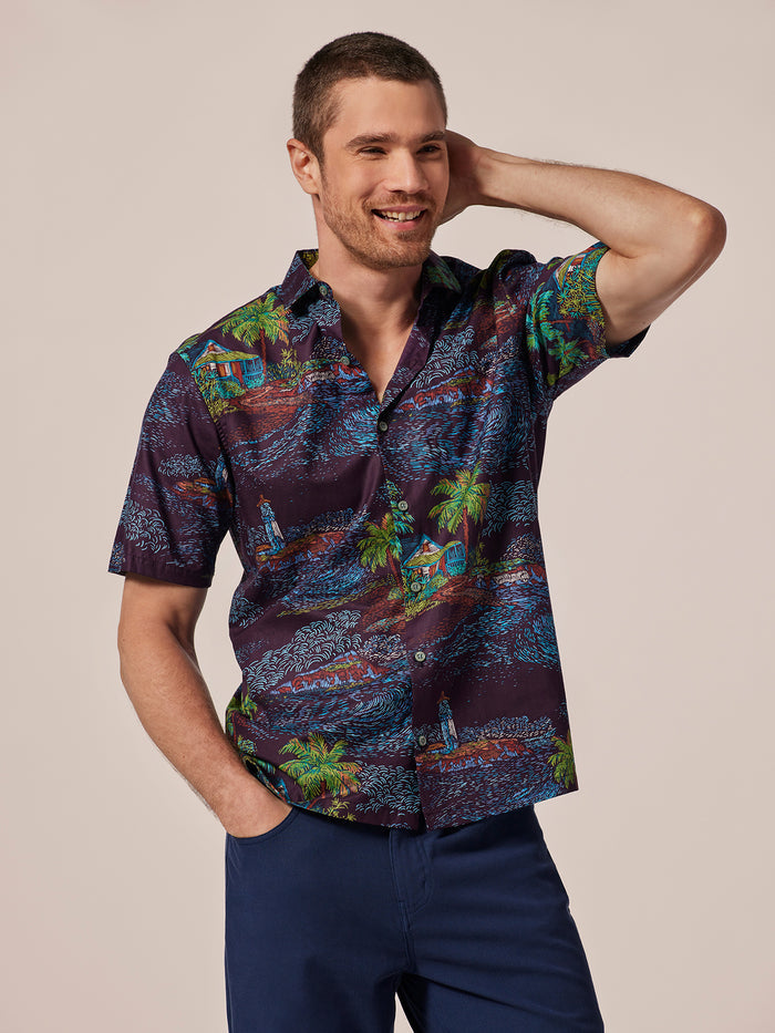 Blue and white tropical-print short-sleeve Hideout shirt, hand behind head, front view.