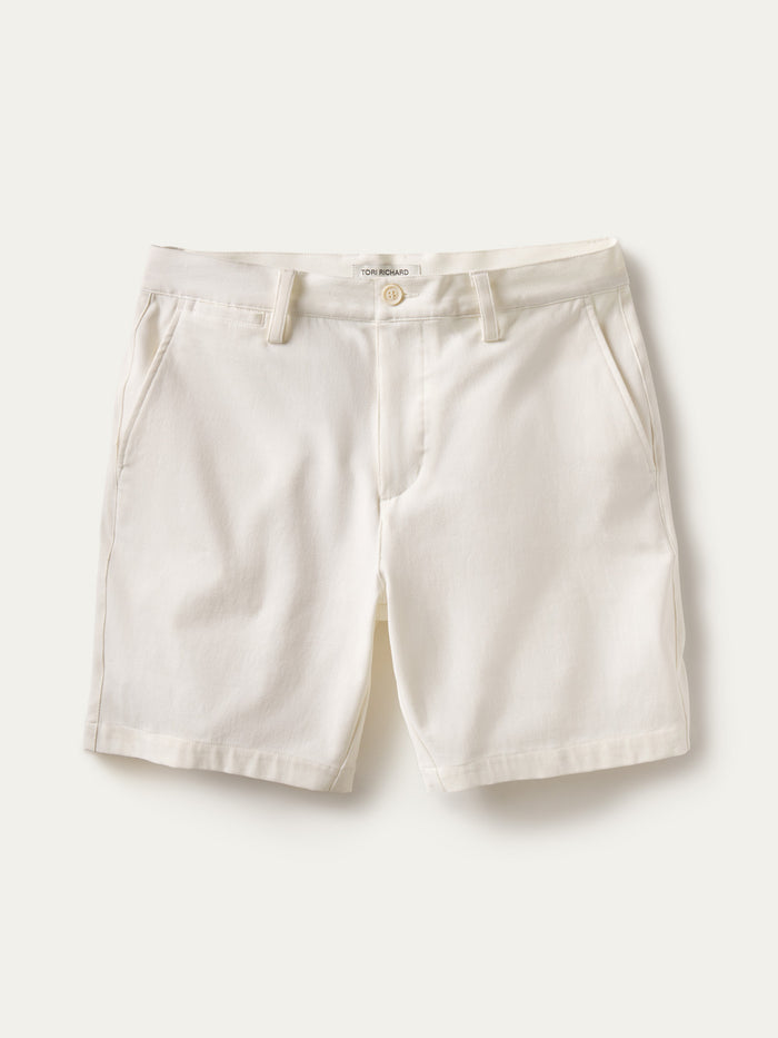 White solid shorts with front pockets, belt loops, and button closure; front view.