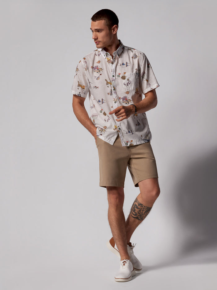 Blue tropical-print short-sleeve shirt with Khaki Honolulu shorts and white shoes, front view.