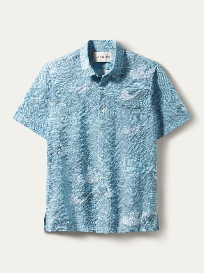 Light blue, cloud-print polyester shirt, short sleeves, front view.