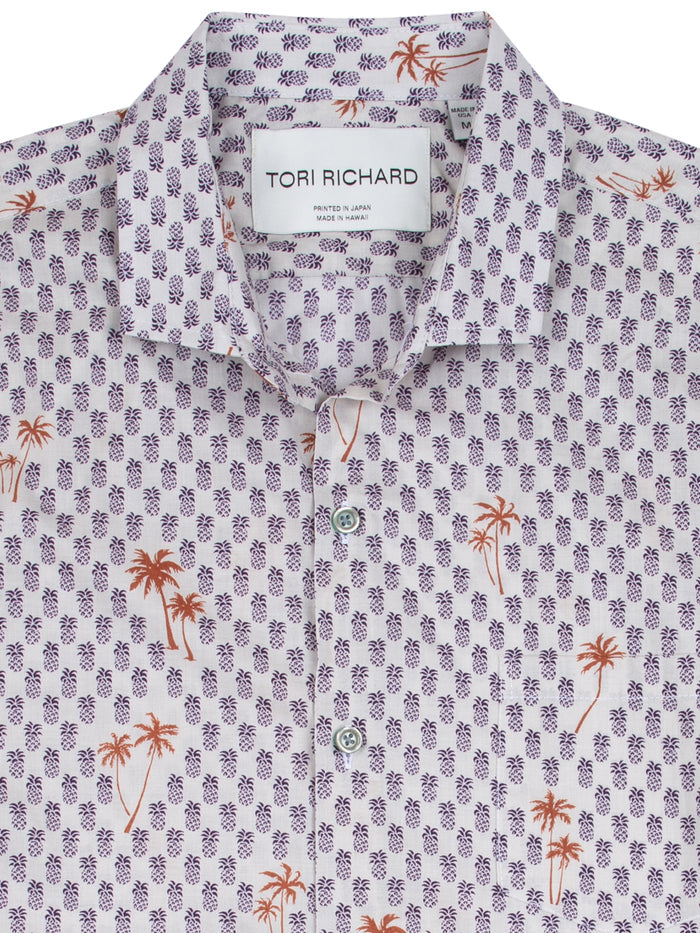 Purple and orange pineapple-and-palm print short-sleeve shirt, close-up view.