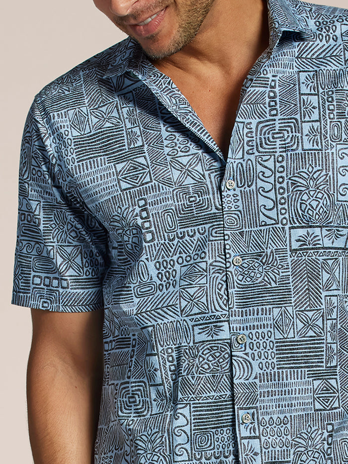 Blue geometric tribal-print short-sleeve Hawaiian shirt, front view.