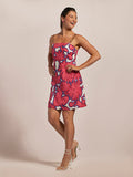 Pink Ikat-print sleeveless dress with gold chain straps, full front view on plain background.