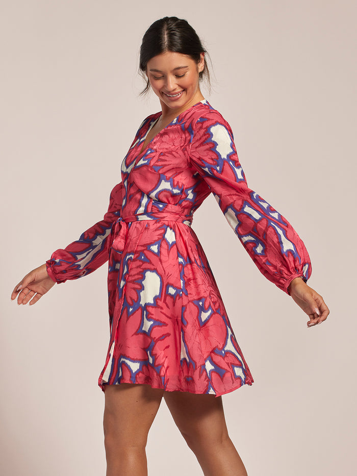 Pink and white ikat-print Maryam dress, woman shown from back looking over shoulder.