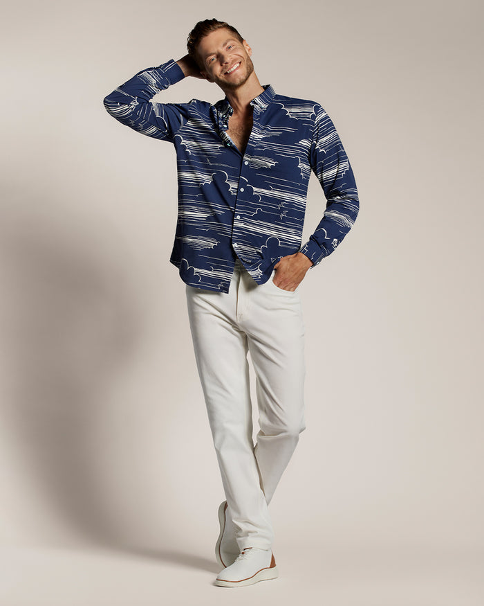 Navy and white long-sleeve performance shirt, man smiling with one hand behind head in both images.