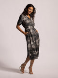 Black and green palm-print short-sleeve dress with pockets, front view.