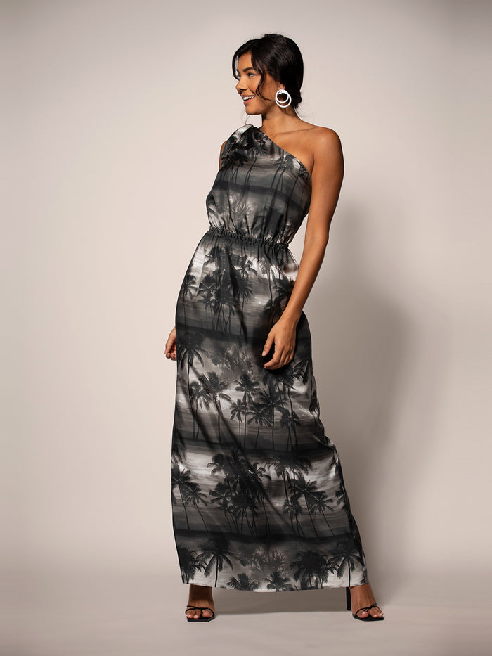 Black and gray palm-print dress, front view, worn by woman against plain background.