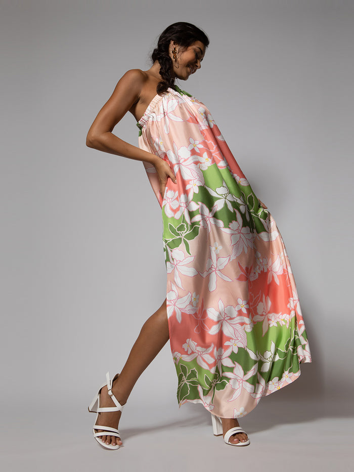 White, knee-length, sleeveless dress with subtle texture, with floral print pink, green, modeled front view on gray background.