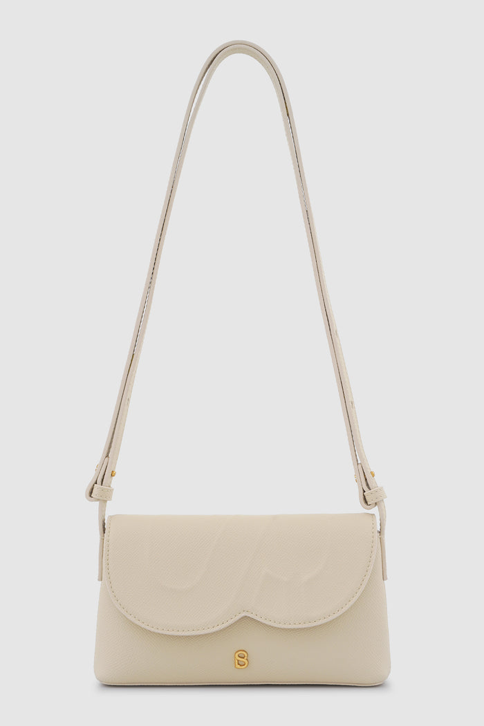 jenny sling bag in beige by buttonscarves front view