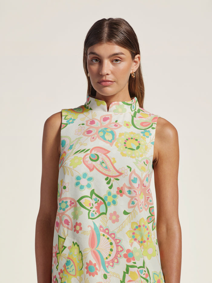 Light pastel floral-print cotton mini shift dress, front view on woman.