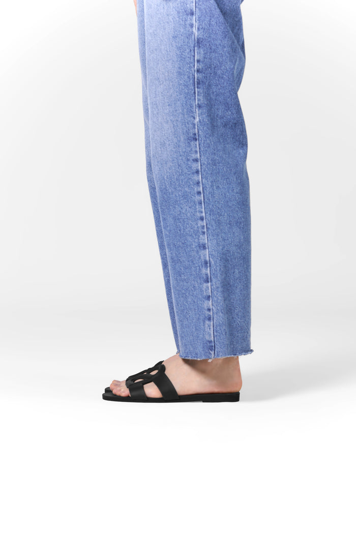 kefi slide sandal in black by buttonscarves worn on feet side view