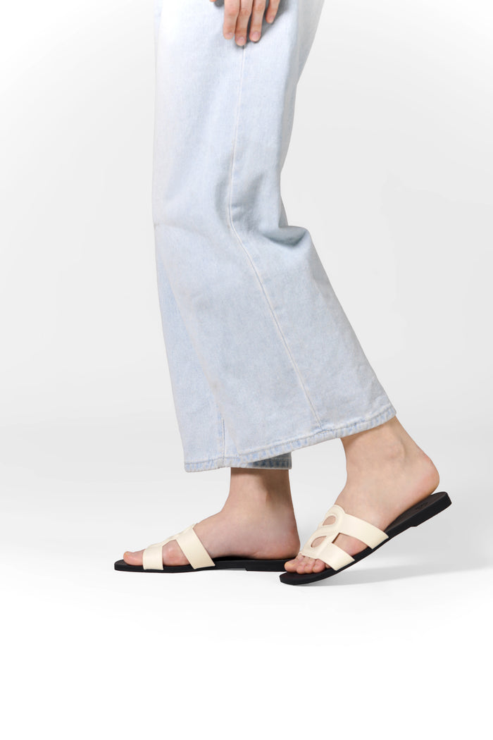 kefi slide sandal in white black by buttonscarves worn on feet side view