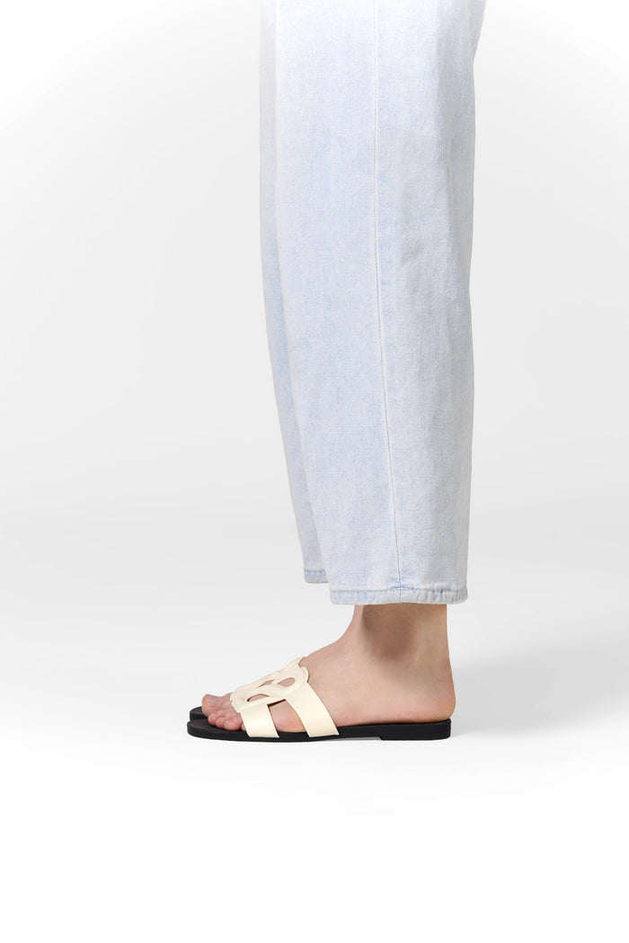 kefi slide sandal in white black by buttonscarves worn on feet side view