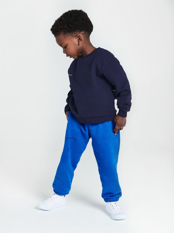 Boy wears Kids' 365 navy midweight sweatshirt, ultra-soft 320 GSM organic cotton, oversized genderless fit, crew neck