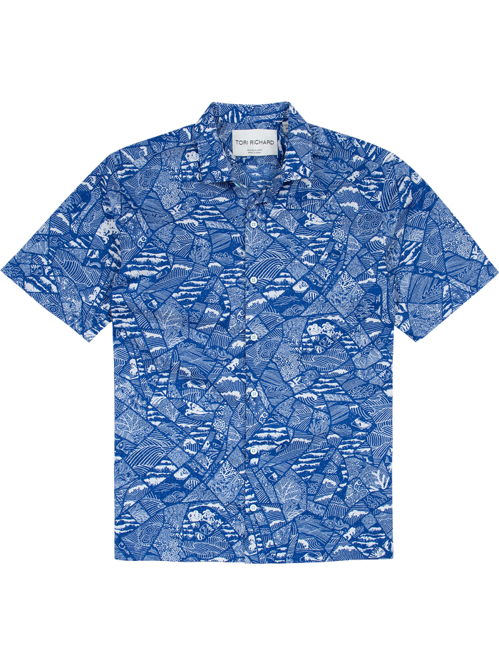Navy and white tropical leaf, wave-mosaic print short-sleeve button-up shirt, flat lay front view.