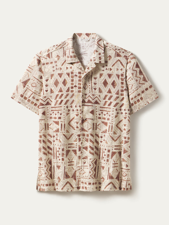 Beige short-sleeve button-up shirt with brown geometric tribal pattern, front view.