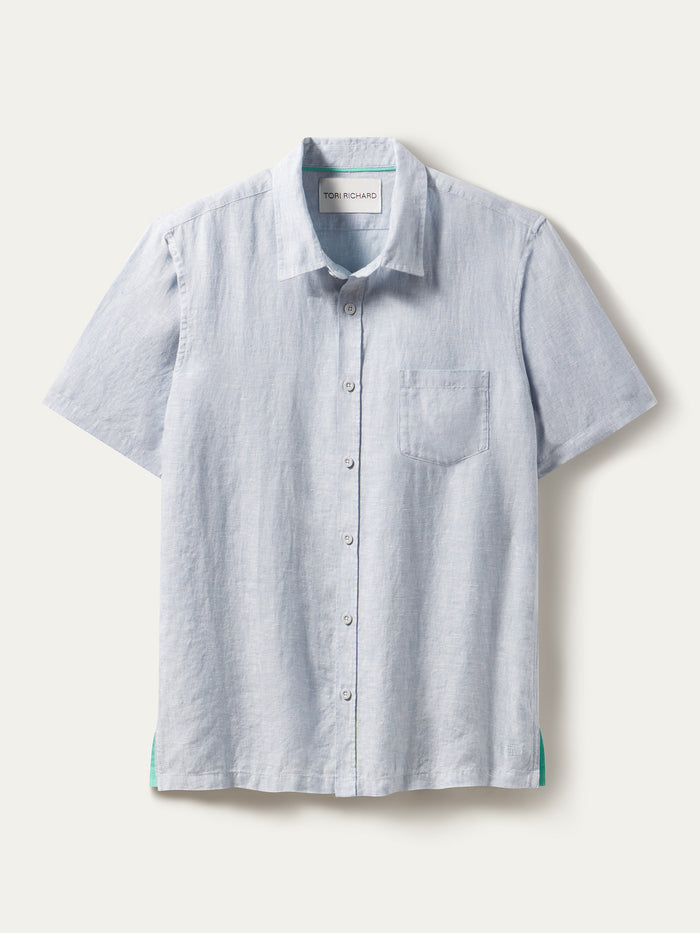 Light blue slub linen shirt with chest pocket detail, front view shown.