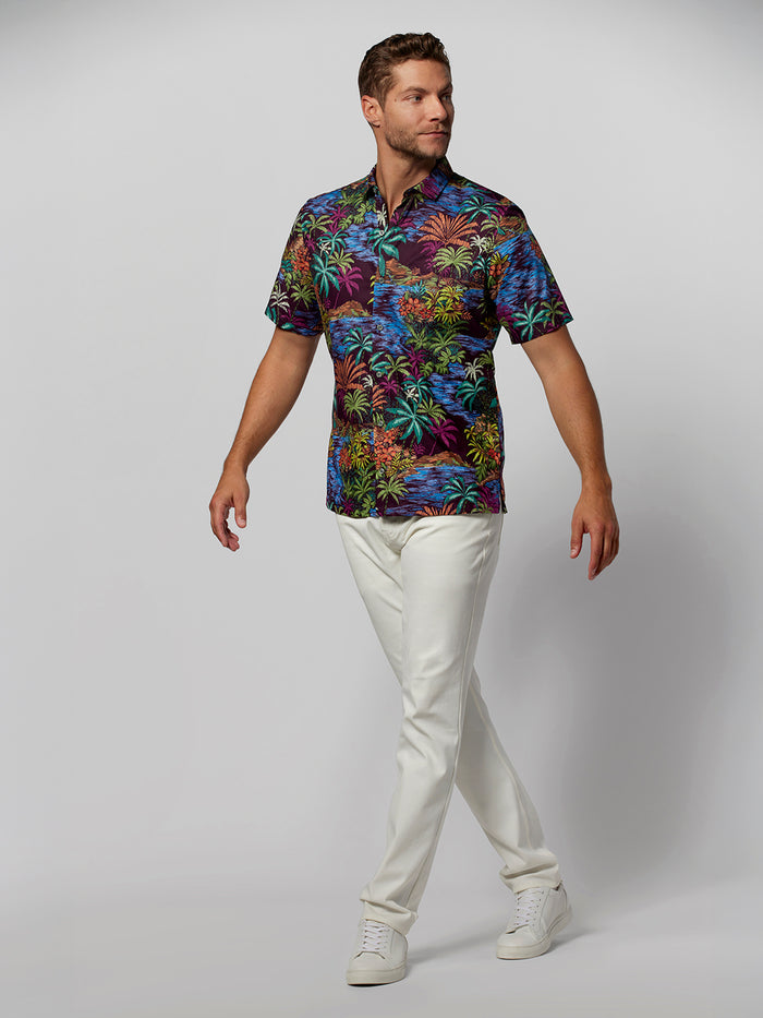 Multicolor abstract-print short-sleeve shirt with white pants, full body view.