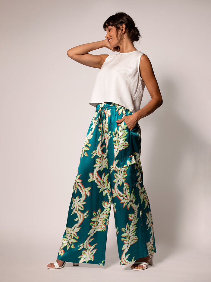 White sleeveless top and multicolor floral-print Lei of the Land Nikita Pant, standing pose.